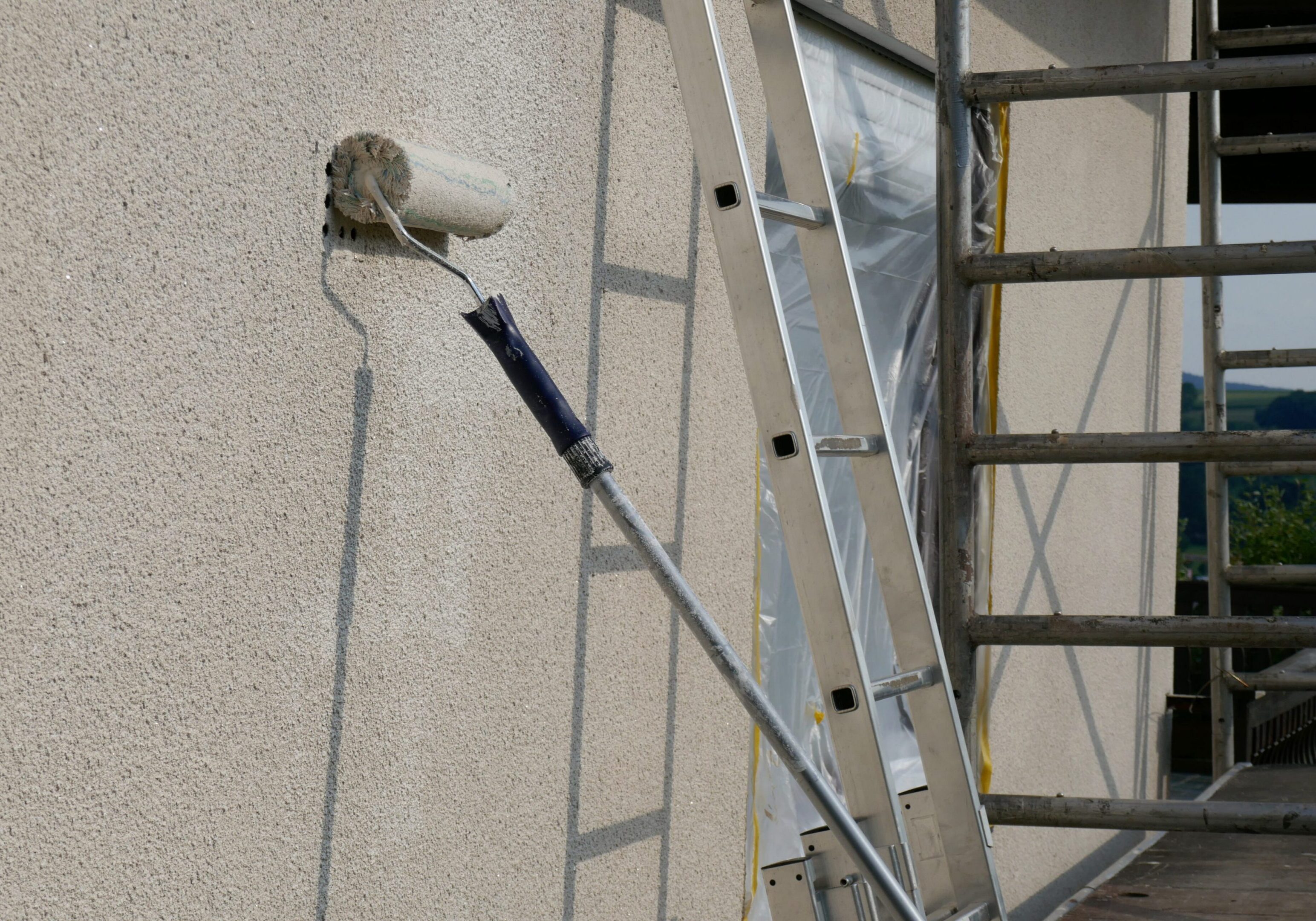 painting walls.Repair and construction .Details of painting walls, roller,staircase, scaffolding and other tools for painting walls of the house outside.home renovation outside